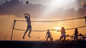 a group of people playing volleyball